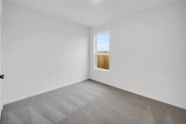 a view of an empty room and a window