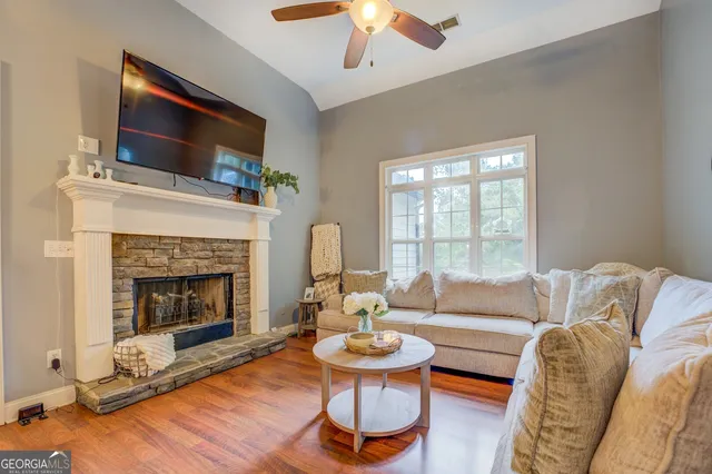 a living room with furniture and wooden floor