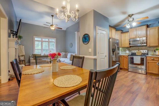 a view of a dining room with furniture and chandelier