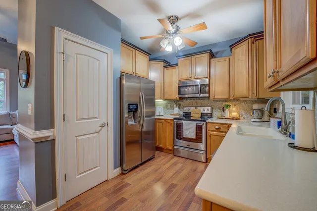 a bedroom with a bed dresser and a dining table