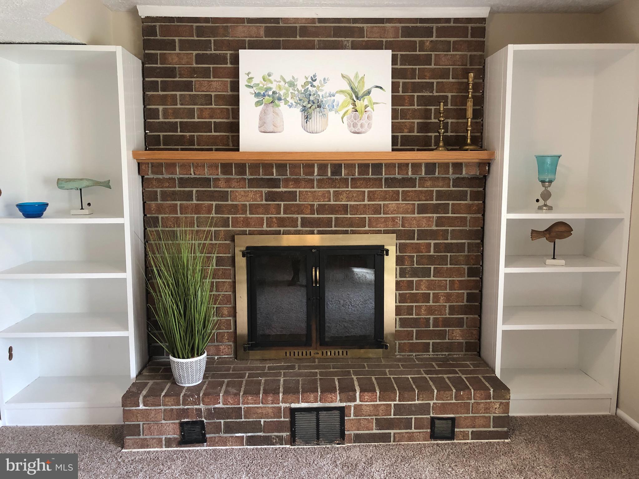 8649 Bali Road Ellicott City, MD 21043 - Photo 22 of 33 Brick wood burning fireplace flanked by shelves!