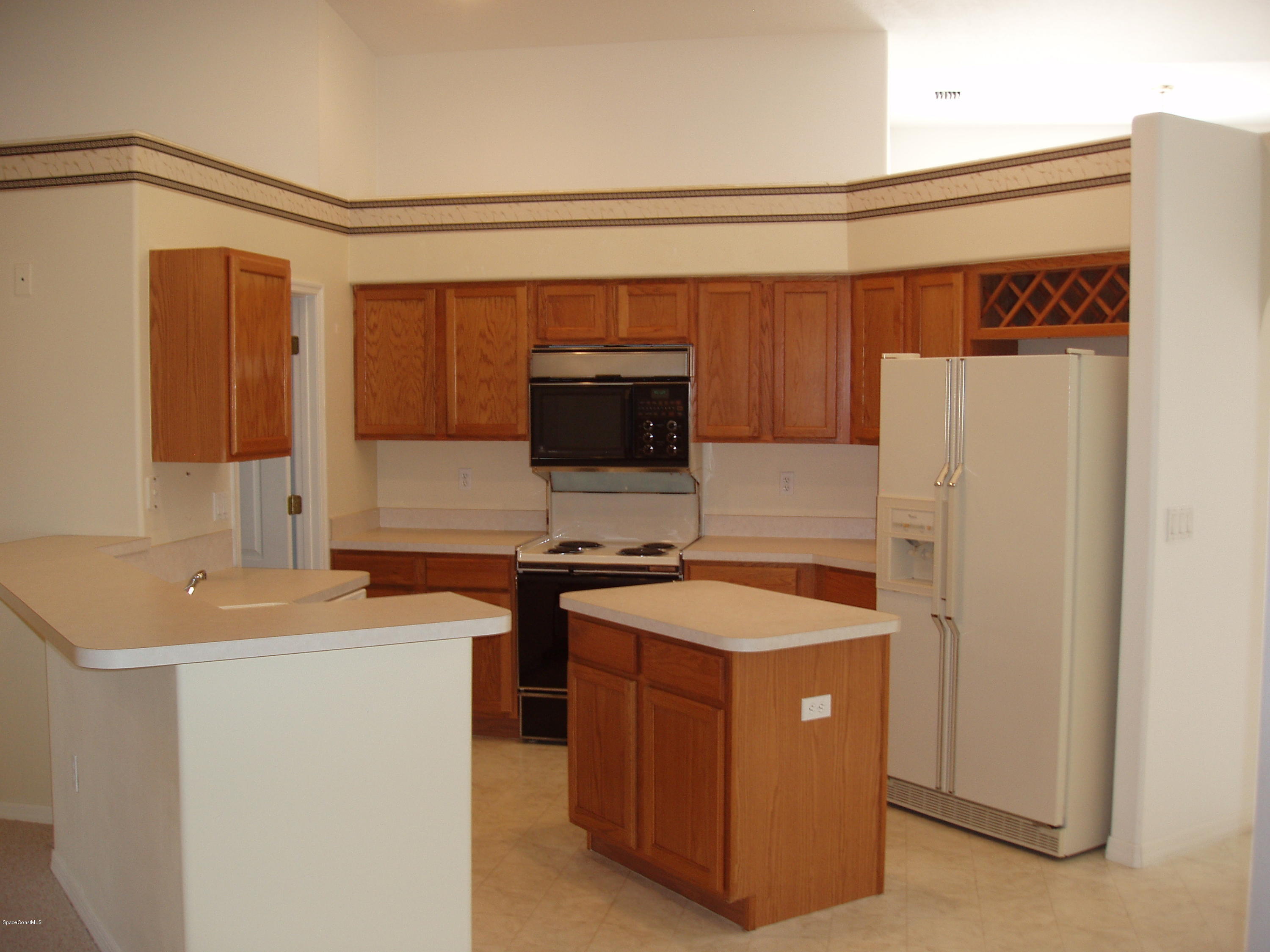740 Riviera Drive Northeast Palm Bay, FL 32905 - Photo 3 of 30 Kitchen Breakfast Bar & Island
