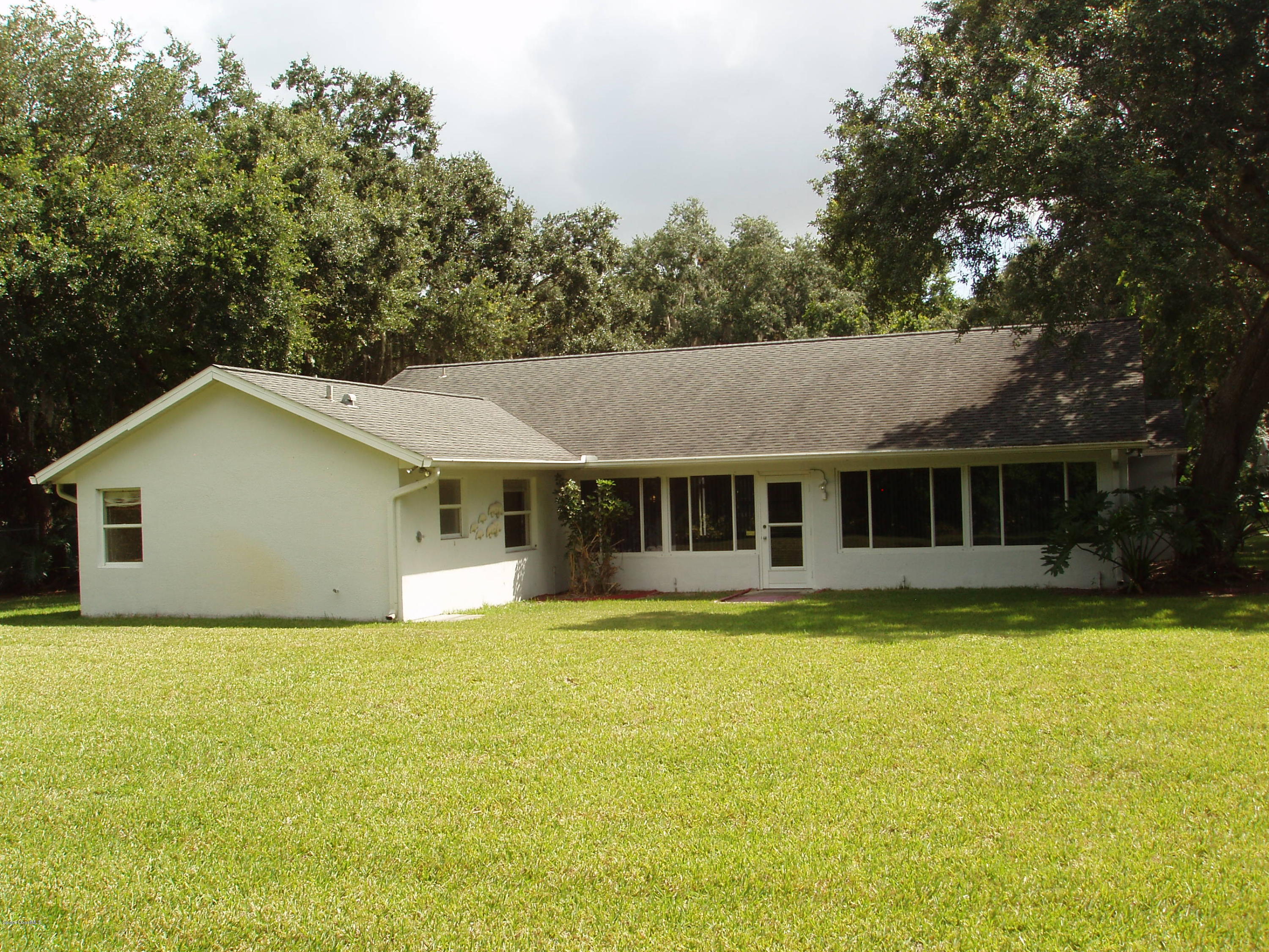 740 Riviera Drive Northeast Palm Bay, FL 32905 - Photo 26 of 30 Backyard to House