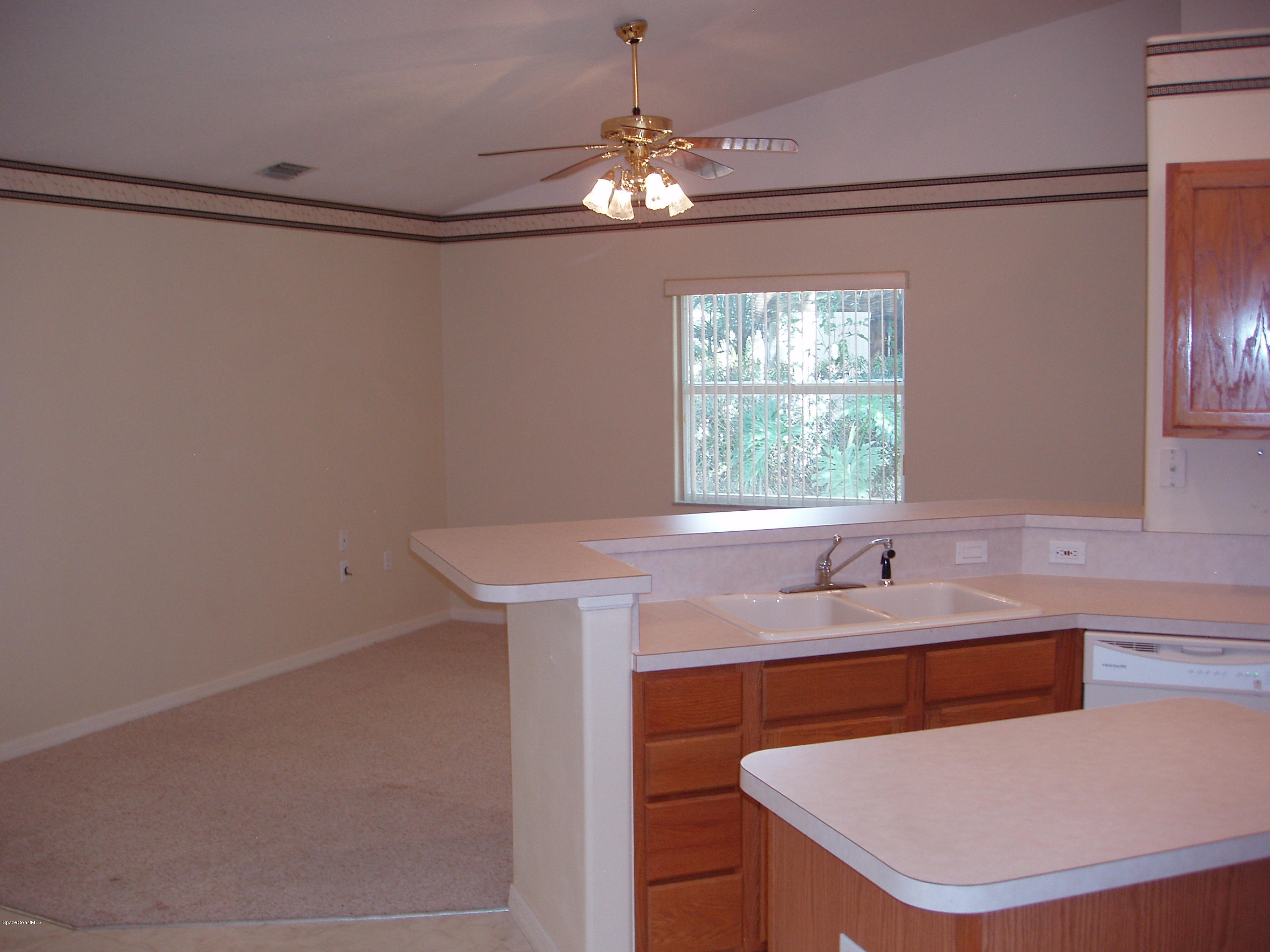 740 Riviera Drive Northeast Palm Bay, FL 32905 - Photo 7 of 30 Kitchen to Family Room