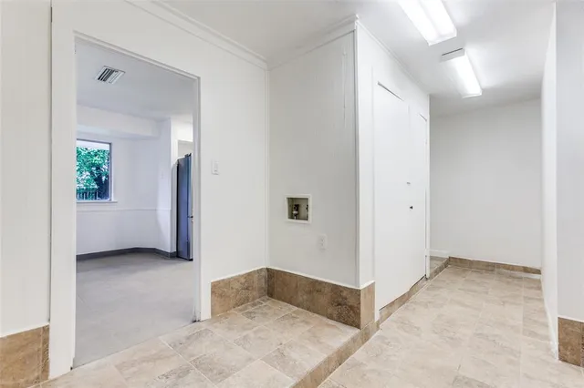 a bedroom with a large bed and a potted plant