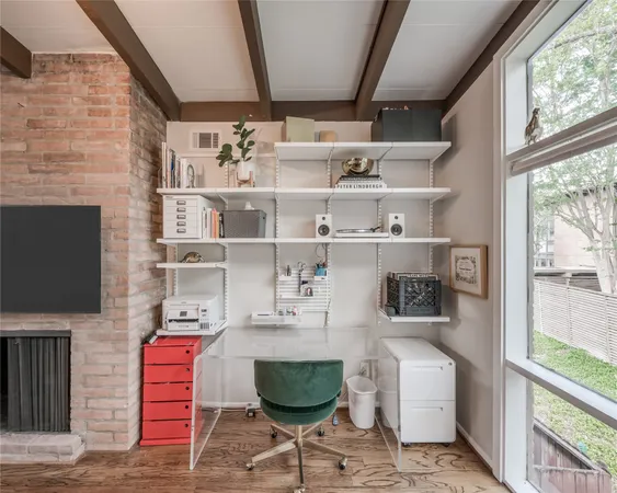 a room with lots of books and a large window