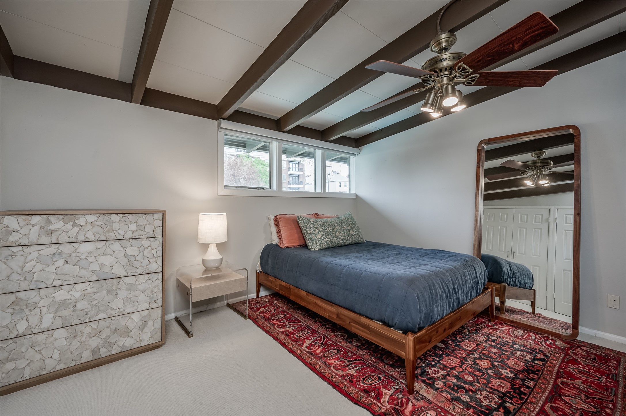 5222 Memorial Drive, Unit 5222 Houston, TX 77007 - Photo 13 of 32 a bedroom with a bed and a chandelier