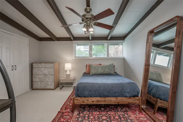 a bedroom with a large bed and a dresser