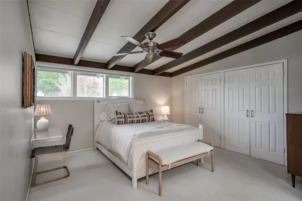 a bedroom with a bed chair and window