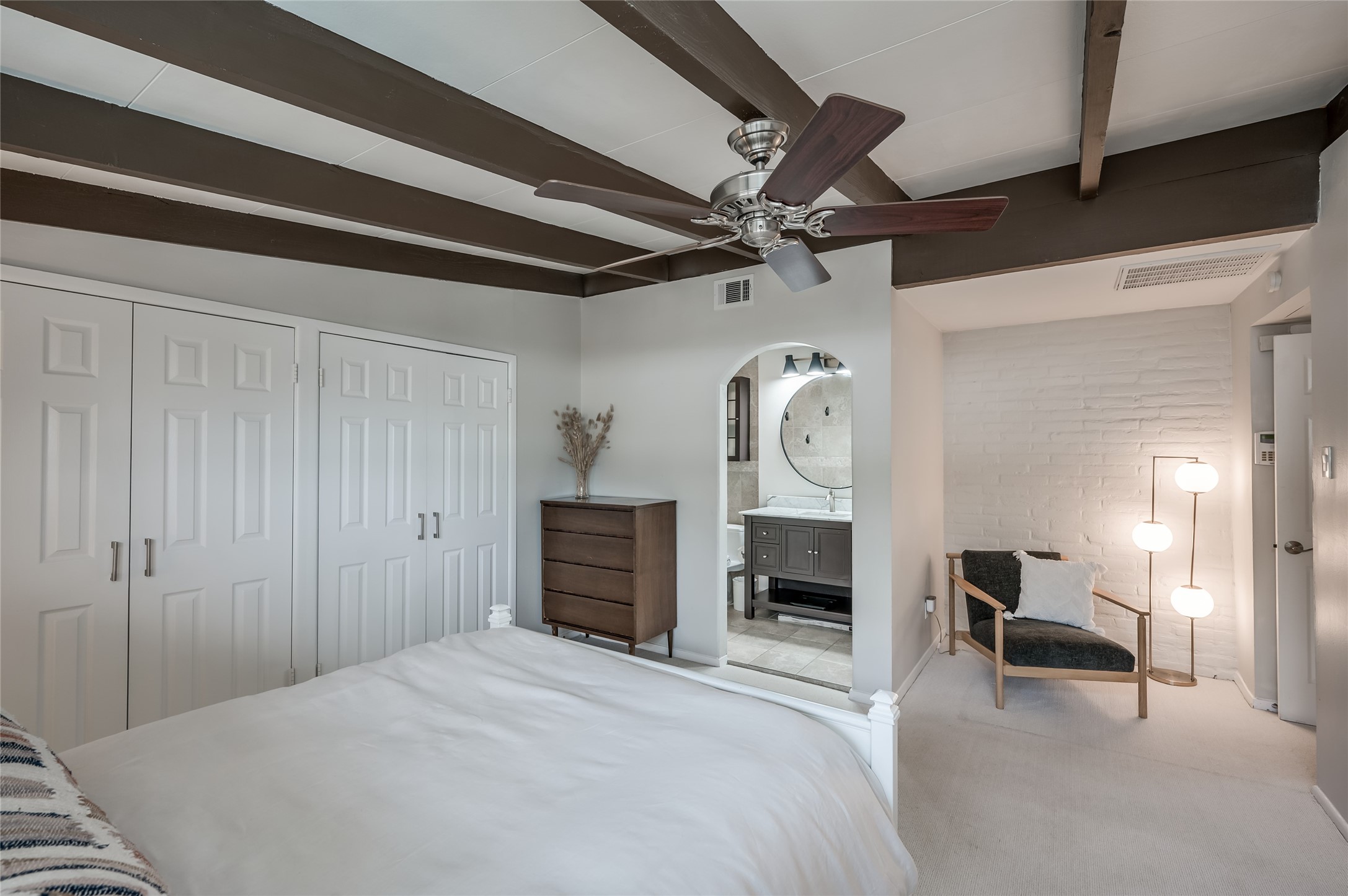 5222 Memorial Drive, Unit 5222 Houston, TX 77007 - Photo 17 of 32 a bedroom with a bed and a chandelier