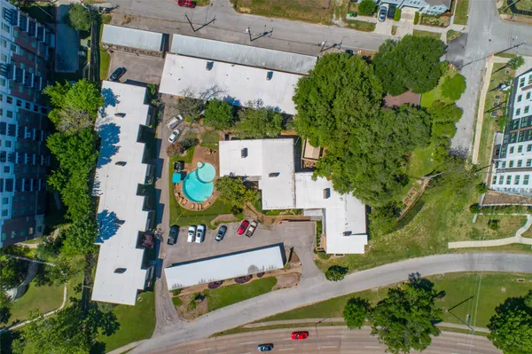 an aerial view of a house with a yard and black white building