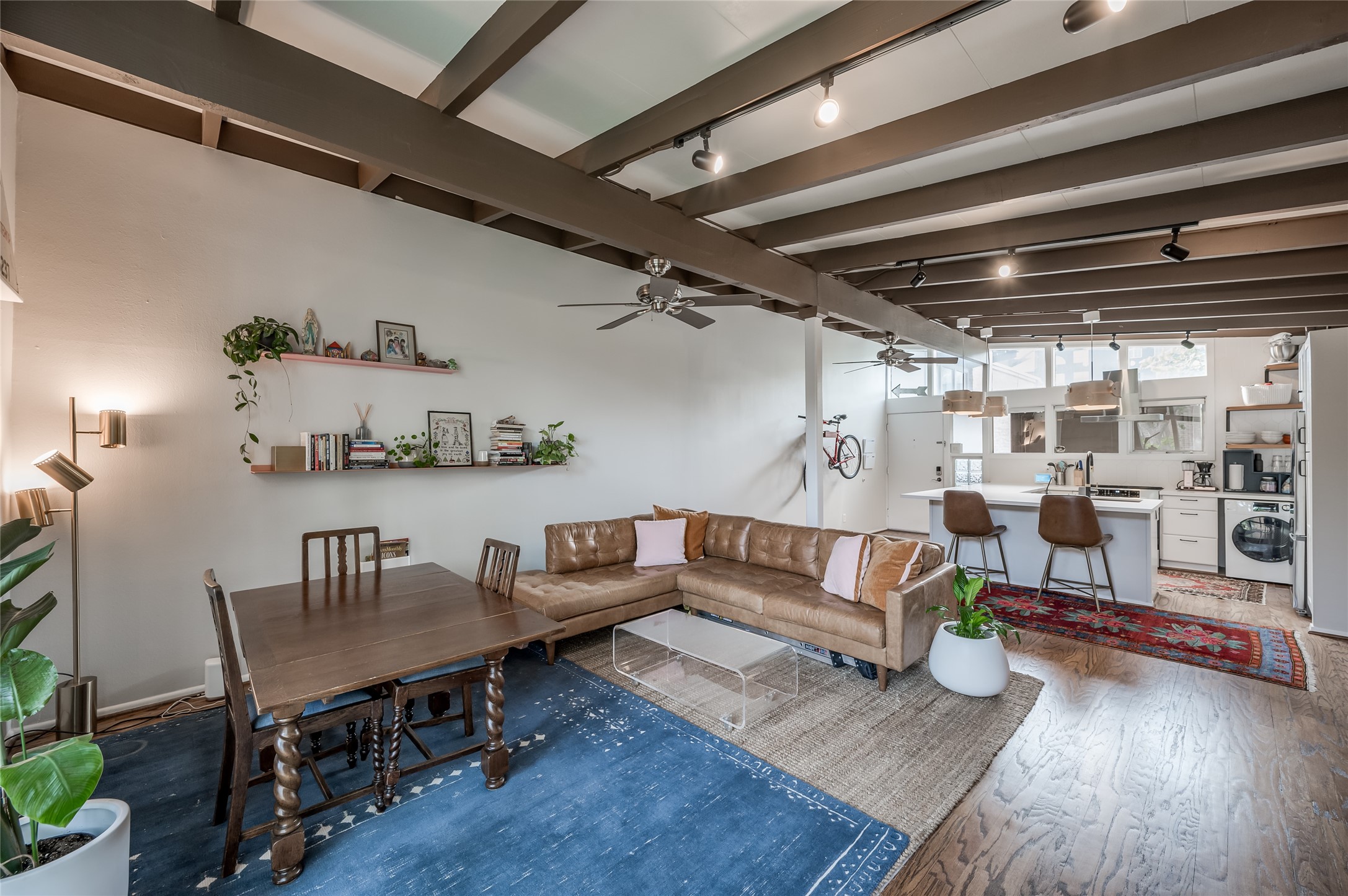 5222 Memorial Drive, Unit 5222 Houston, TX 77007 - Photo 8 of 32 a living room with lots of furniture and a dining table with wooden floor