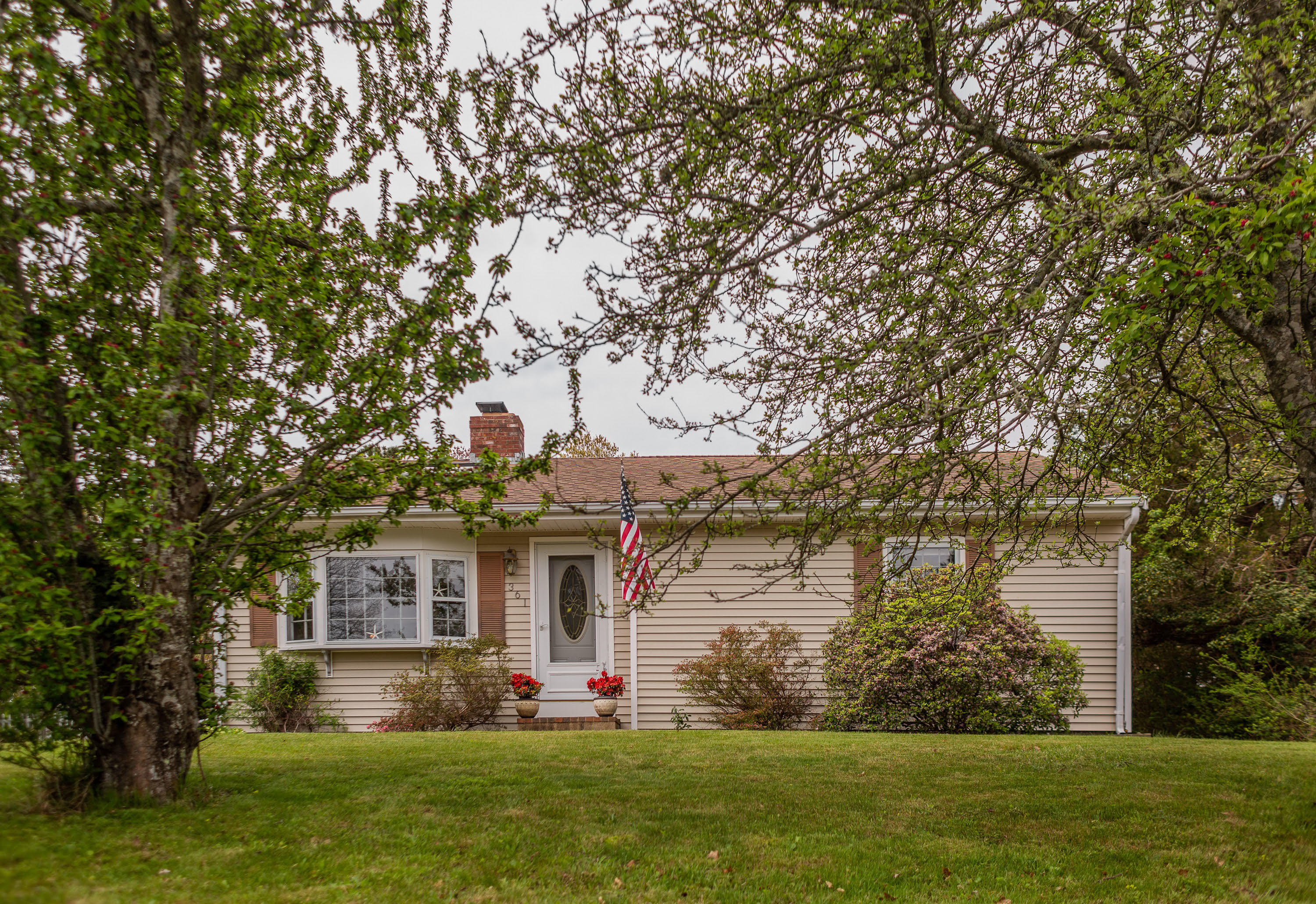361 Megan Road Hyannis, MA 02601 - Photo 1 of 18 a front view of a house with a garden and trees