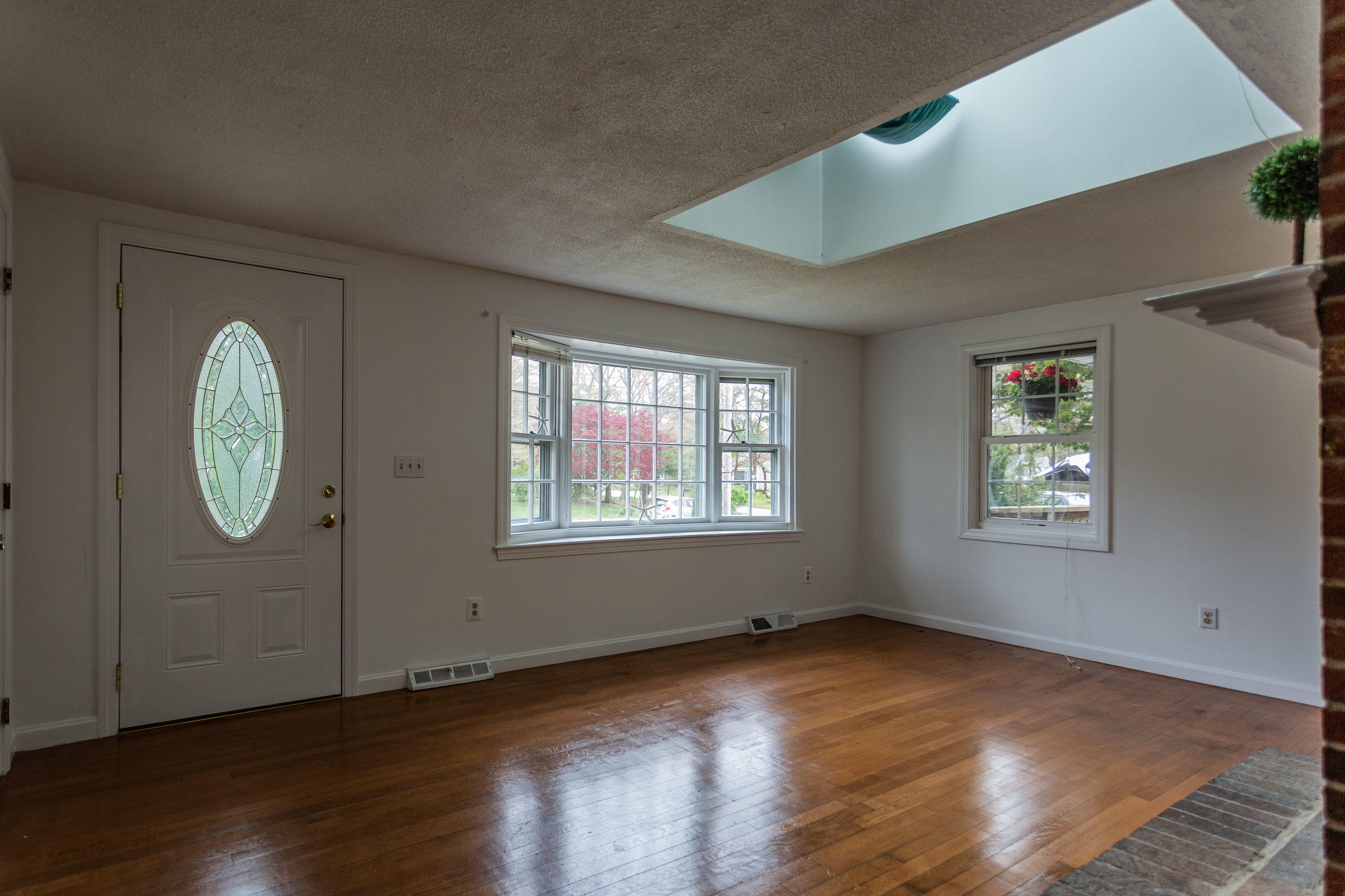 361 Megan Road Hyannis, MA 02601 - Photo 2 of 18 an empty room with wooden floor and windows