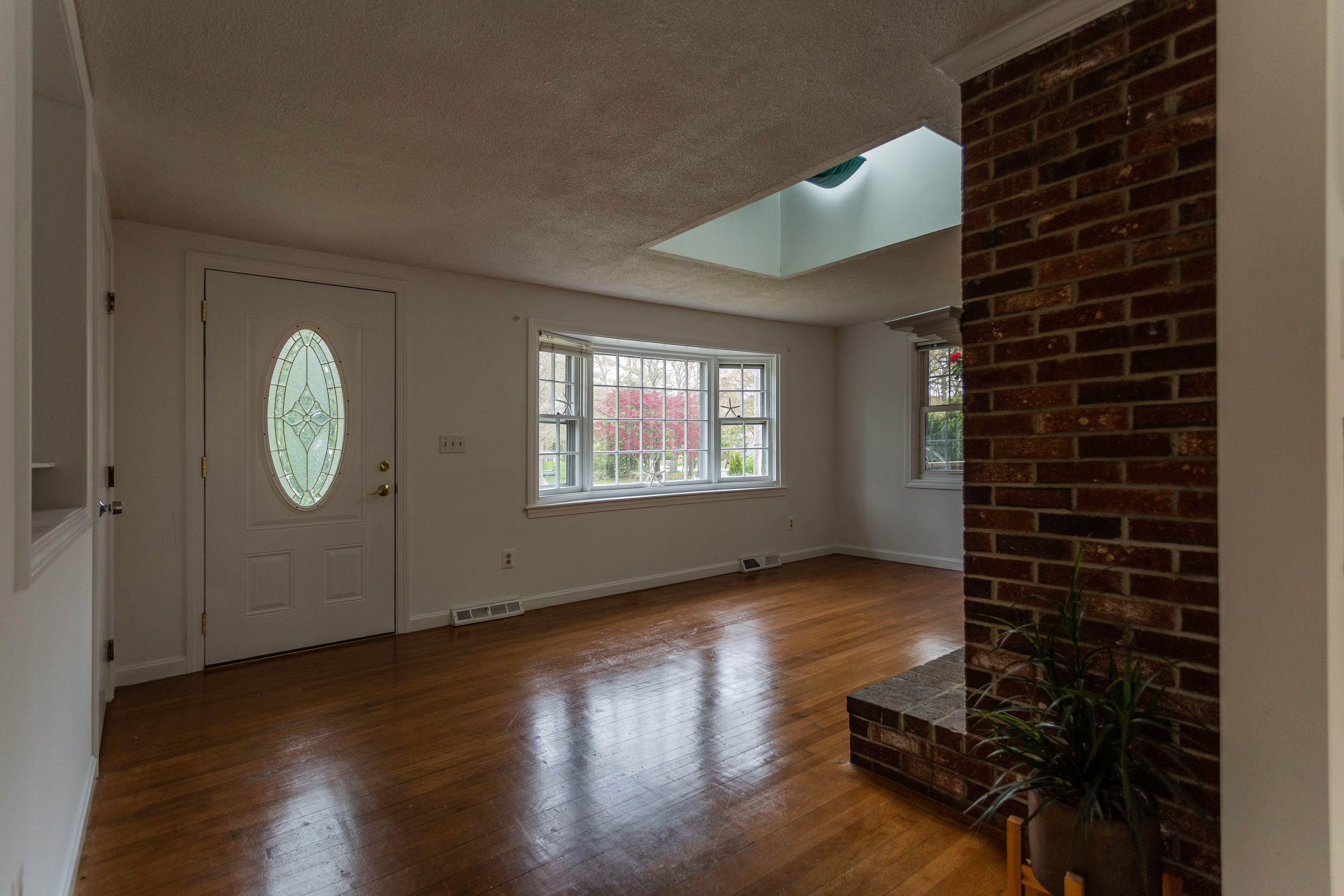 361 Megan Road Hyannis, MA 02601 - Photo 3 of 18 a view of an empty room with wooden floor and a window