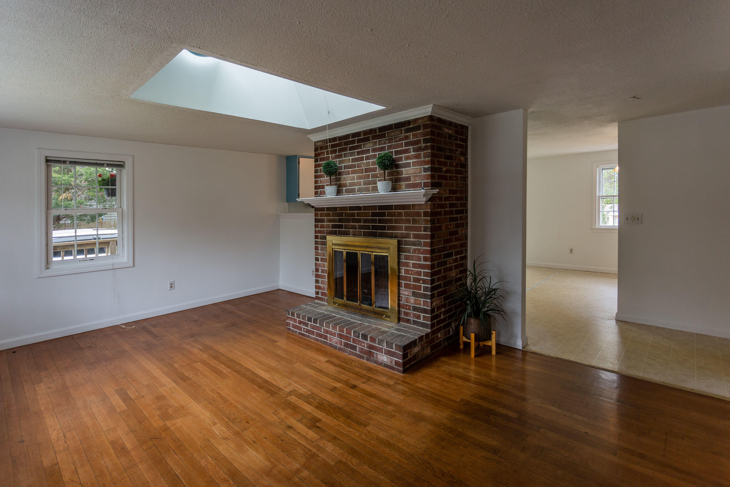 361 Megan Road Hyannis, MA 02601 - Photo 5 of 18 a view of an empty room with wooden floor fireplace and a window