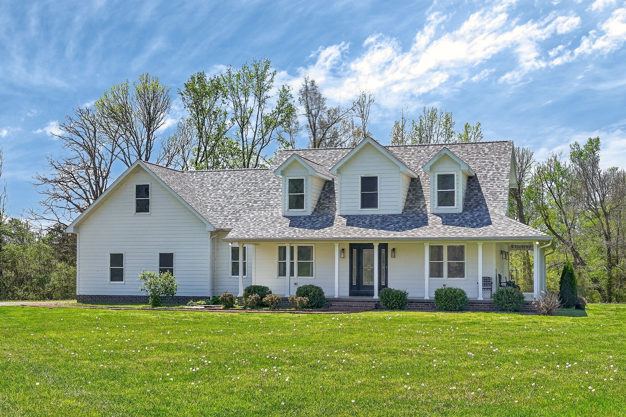 302 Ligon Street Baxter, TN 38544 - Photo 2 of 68 a front view of a house with a garden