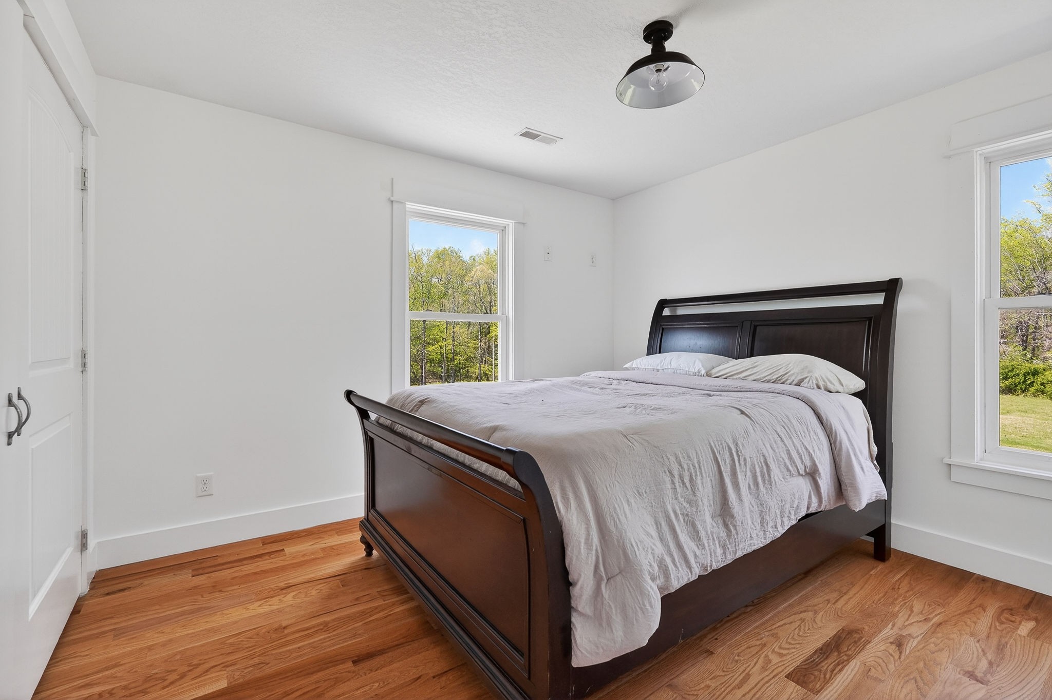 302 Ligon Street Baxter, TN 38544 - Photo 35 of 68 a bed sitting in a bedroom next to a window