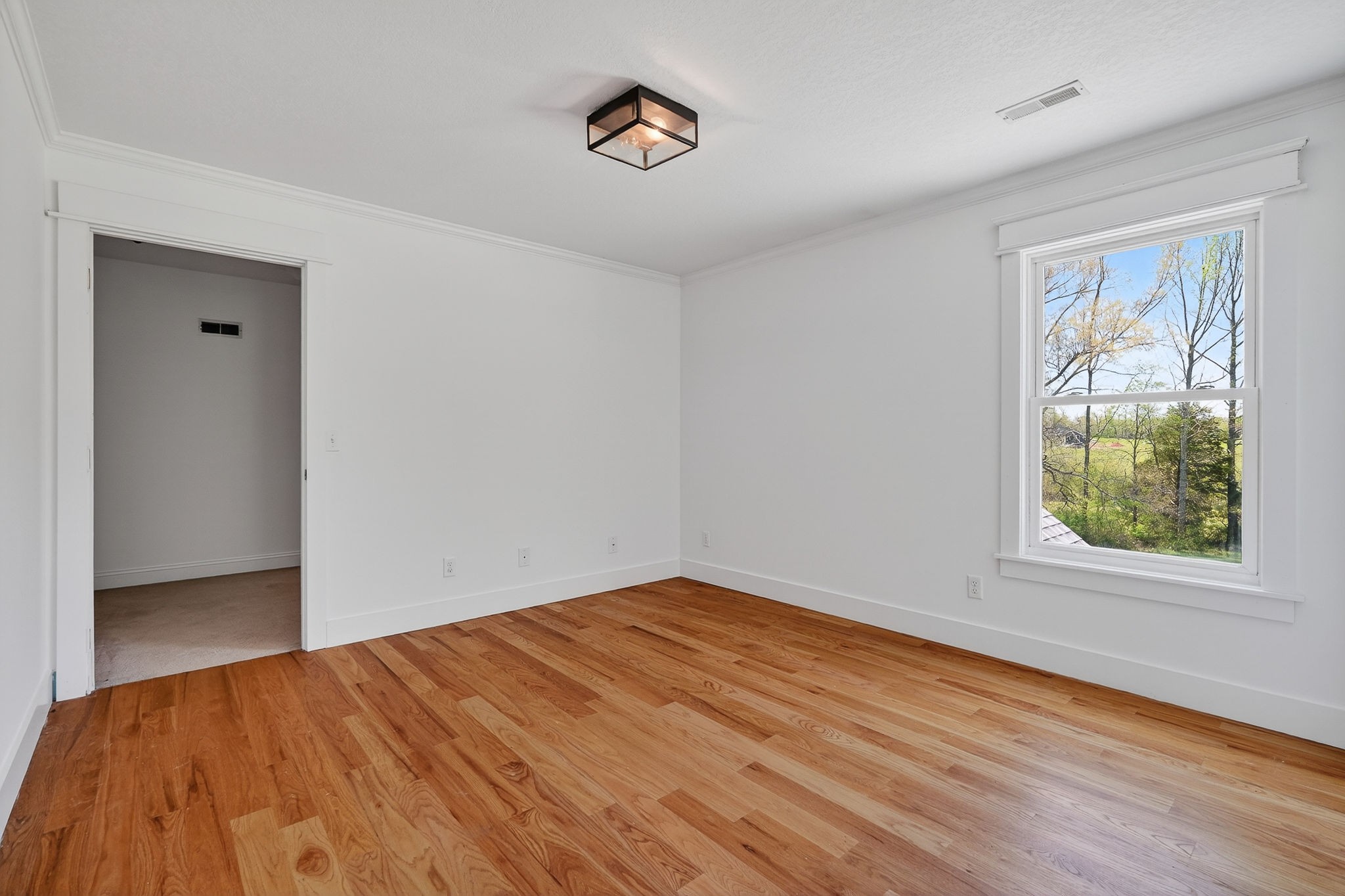 302 Ligon Street Baxter, TN 38544 - Photo 37 of 68 a view of empty room with wooden floor and fan