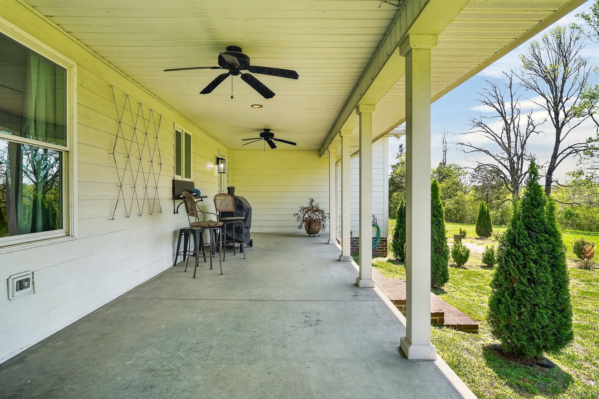 302 Ligon Street Baxter, TN 38544 - Photo 53 of 68 a view of a porch with chairs and backyard