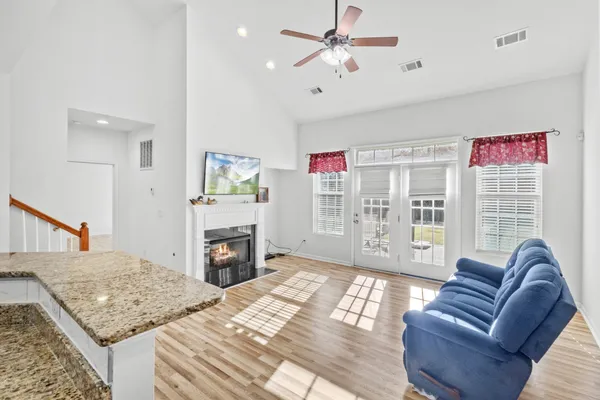 a living room with furniture a fireplace and a flat screen tv