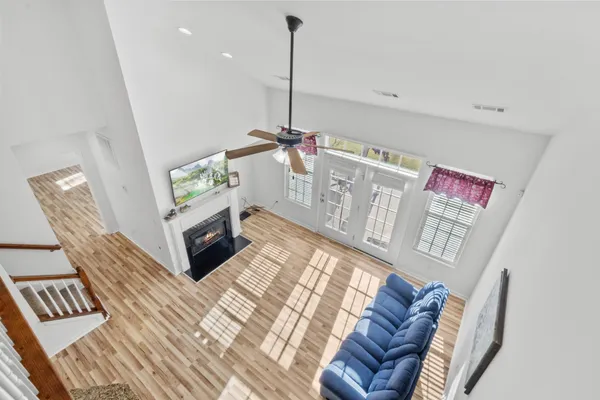 a kitchen with stainless steel appliances granite countertop a refrigerator a stove a sink cabinets and a dining table