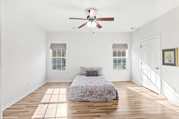 a bedroom with a bed and a ceiling fan