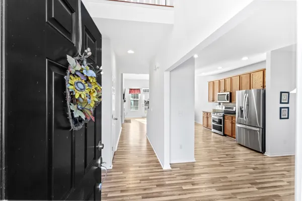 a view of a hallway with wooden floor