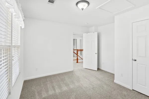 an empty room with a fan and a fan