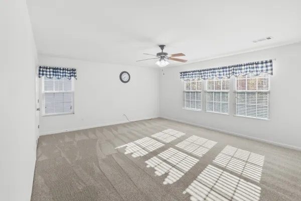 a view of an empty room and a window