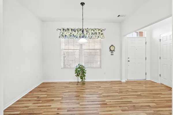 a spacious bedroom with a balcony a bed and wooden floor
