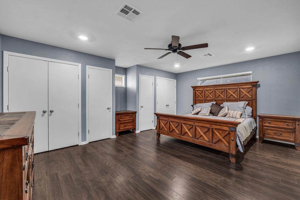 4325 Shady Glen Drive Waco, TX 76708 - Photo 13 of 40 a spacious bedroom with a bed and a chandelier