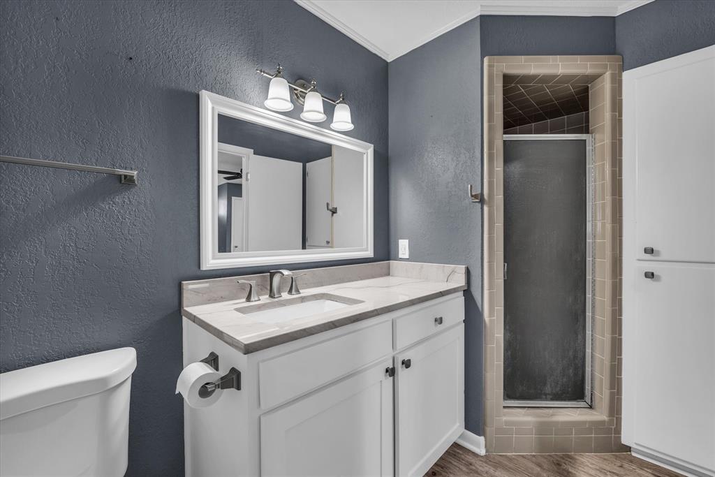 4325 Shady Glen Drive Waco, TX 76708 - Photo 15 of 40 a bathroom with a granite countertop sink a toilet and a mirror