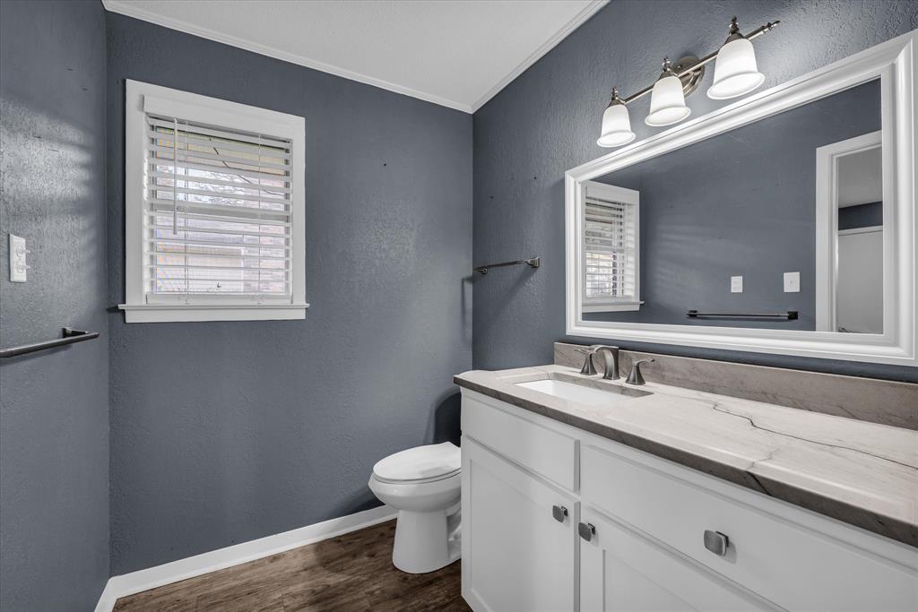 4325 Shady Glen Drive Waco, TX 76708 - Photo 16 of 40 a bathroom with a sink a toilet and mirror