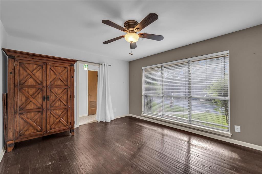 4325 Shady Glen Drive Waco, TX 76708 - Photo 19 of 40 a view of an empty room with wooden floor and a window