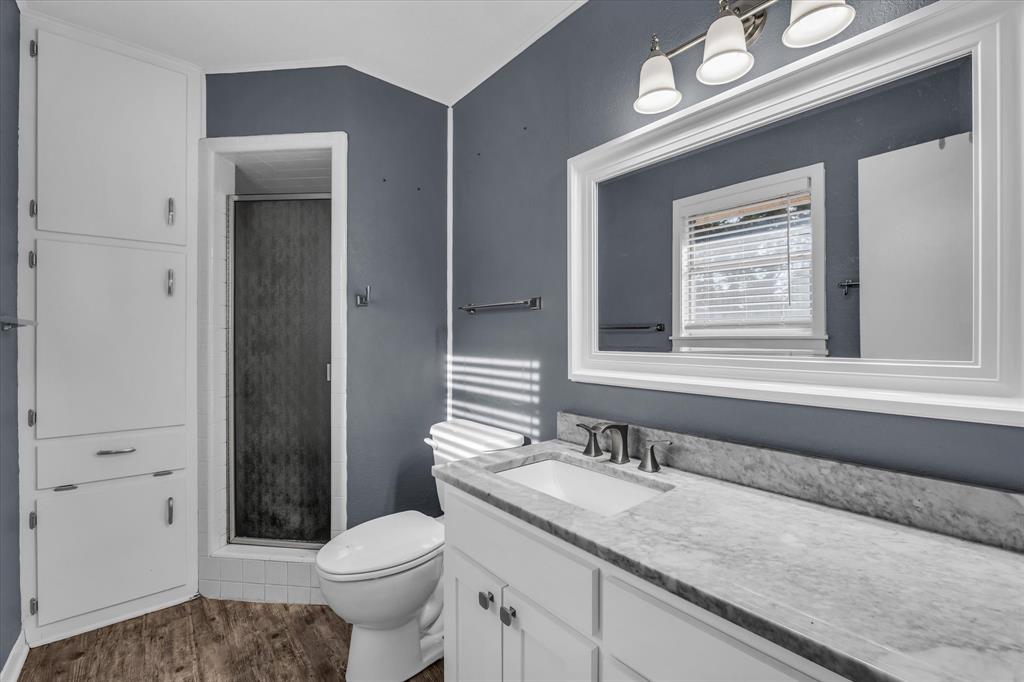 4325 Shady Glen Drive Waco, TX 76708 - Photo 27 of 40 a bathroom with a granite countertop sink toilet and shower