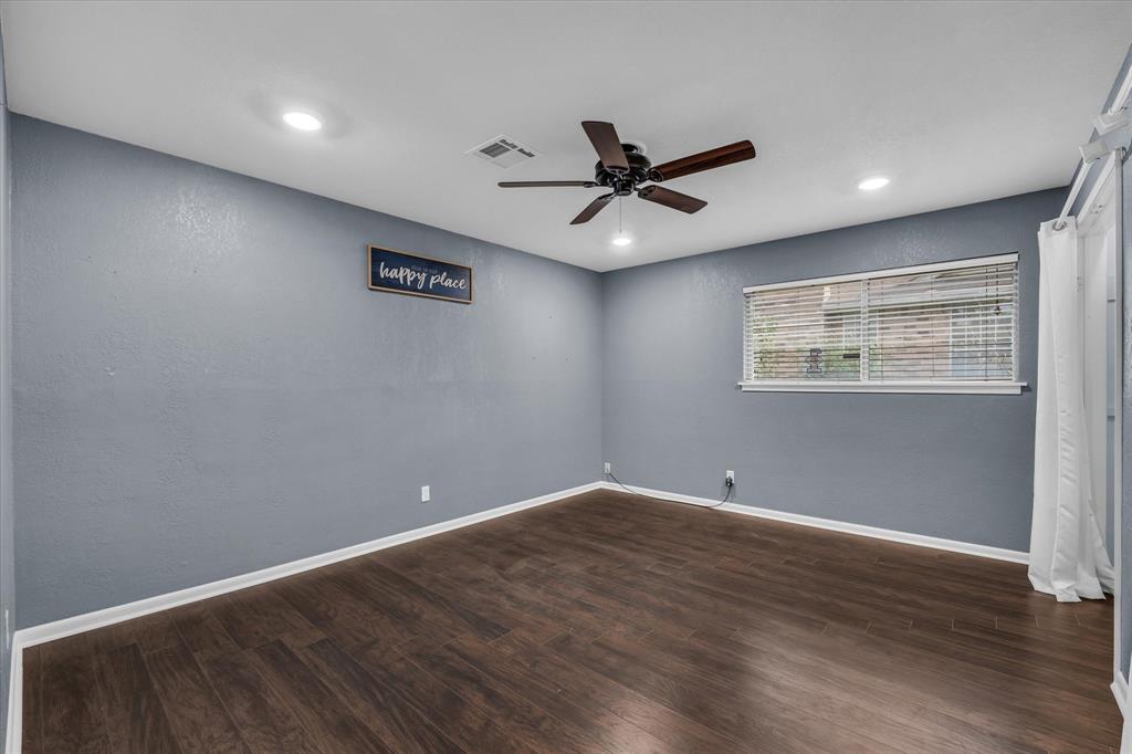 4325 Shady Glen Drive Waco, TX 76708 - Photo 29 of 40 a view of an empty room with wooden floor and a window