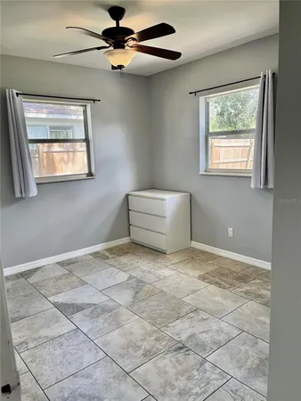 a view of room with window and ceiling fan
