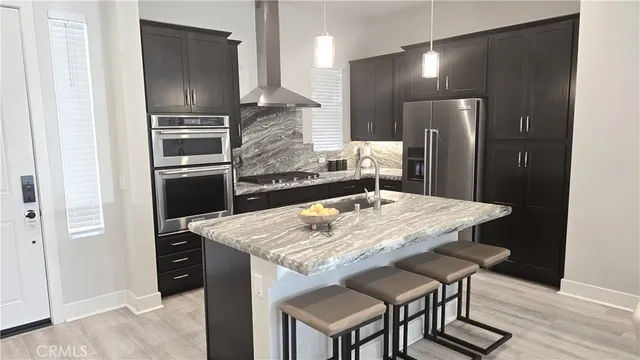a kitchen with granite countertop stainless steel appliances a stove a sink and a microwave