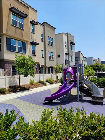 a living room with furniture gym equipment and a view of kitchen