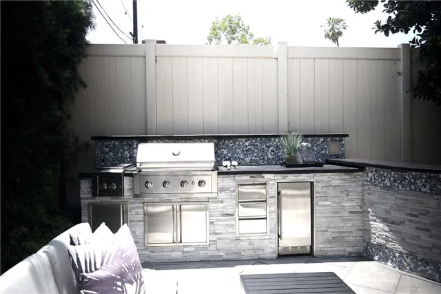 a backyard of a house with table and chairs