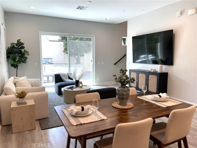 a kitchen with a table chairs and a refrigerator