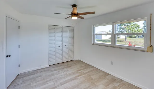 a open kitchen with a sink and wooden floor