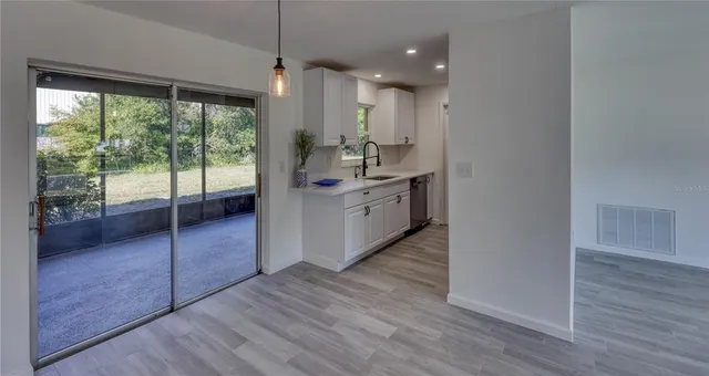 a outdoor space with lots of tables a computer on a table and chairs