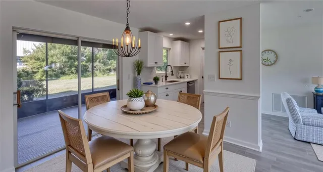 a dining room with furniture a window and wooden floor
