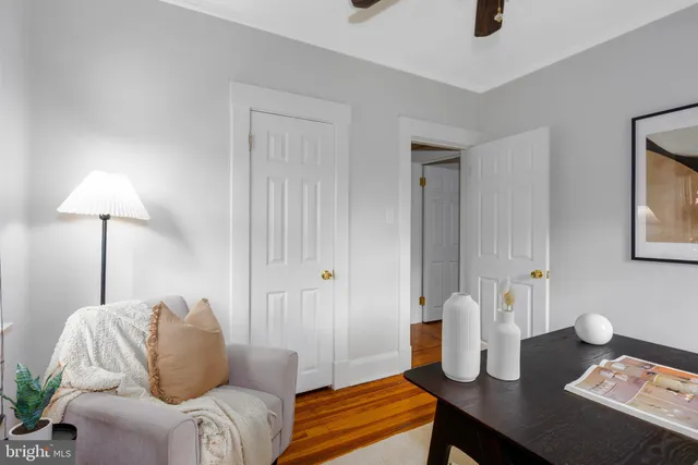a living room with furniture and a lamp