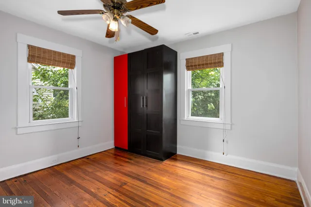 an empty room with windows and closet