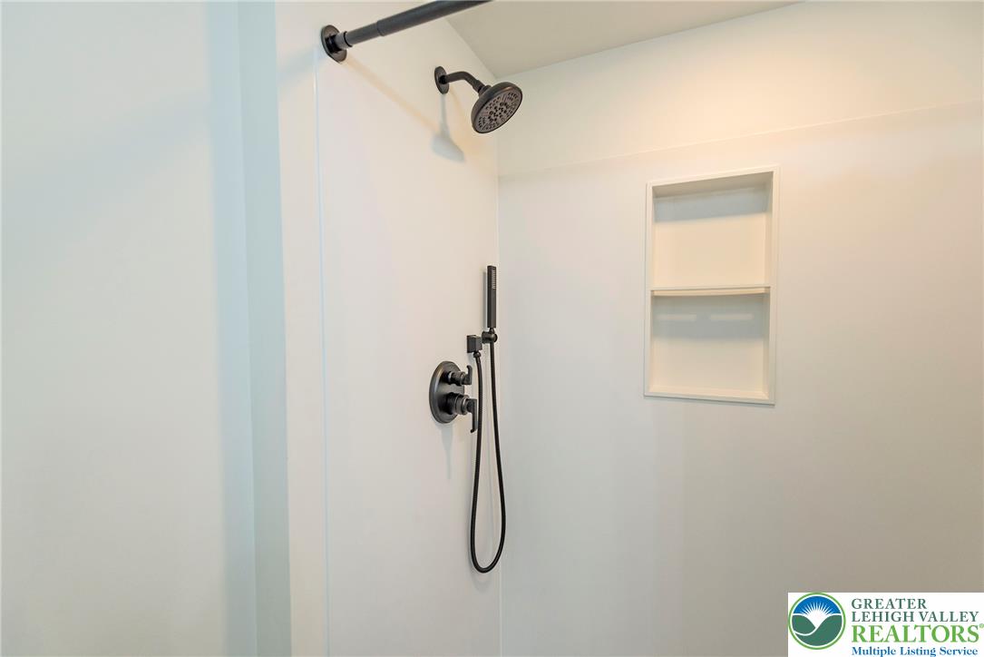 72 Allegheny Road Mount Bethel, PA 18343 - Photo 27 of 72 Modern shower with black fixtures and recessed shelving for a clean aesthetic.