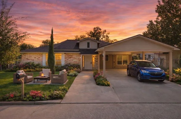 a front view of a house with garden