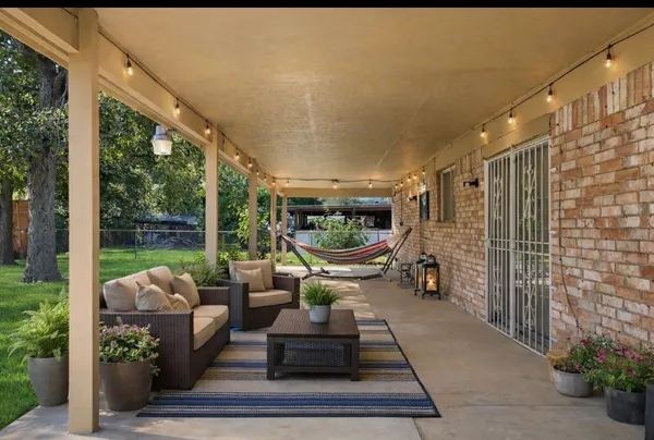 a outdoor space with patio the couches and a dining table with garden view